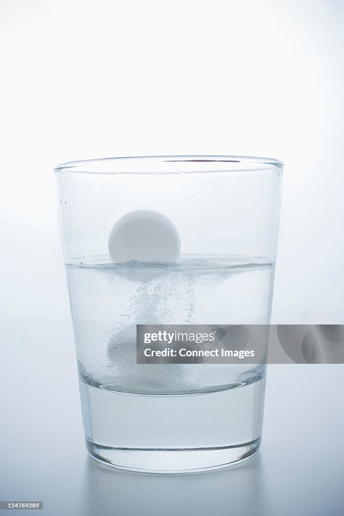 Pill in glass of water