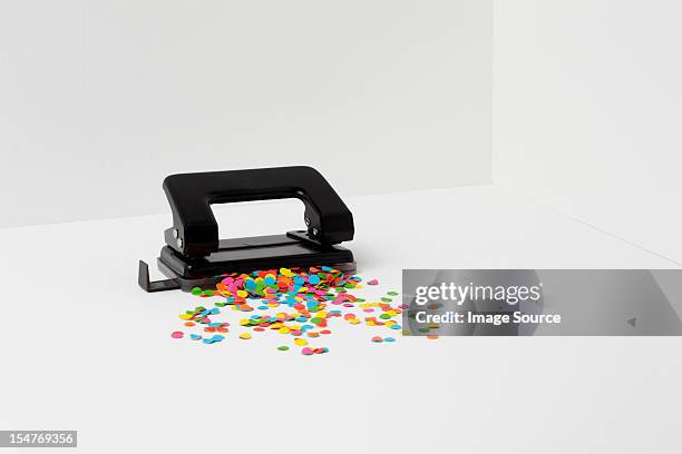 hole puncher with multi coloured paper - hole punch stock pictures, royalty-free photos & images