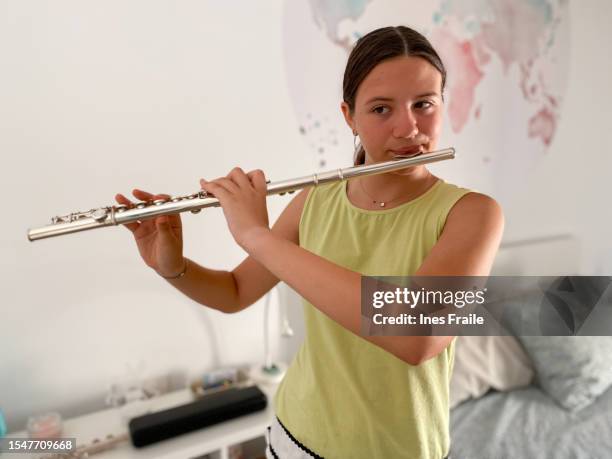 young teenage girl playing the flute - flauta imagens e fotografias de stock