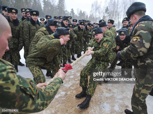 Belarus interior troops encourage their team as they compete in a tug of war during a sport competition to mark Maslenitsa , an ancient week long...