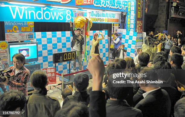 Shop staffs and customers count down during the Microsoft Windows 8 launching event on october 26, 2012 in Tokyo, Japan.