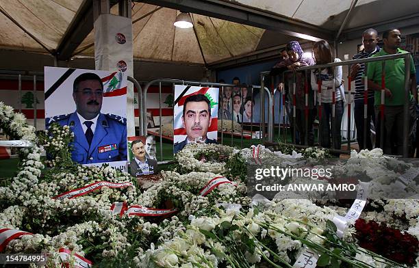 Lebanese mourners visit the tomb of slain police intelligence chief General Wissam al-Hassan and his and his bodyguard Ahmed Sahyuni next to the tomb...