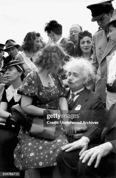German-Swiss-American mathematician and physicist Albert Einstein , with his stepdaughter, sculptor Margot Einstein , on his lap, attends the opening...