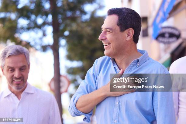 The president of the Popular Party of Andalusia, Juanma Moreno, greets during media attention in the town of Dos Hermanas, July 16, 2023 in Seville ....