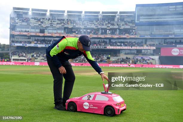 Umpire Graham Lloyd takes the ball from the Vitality car ahead of the Vitality Blast T20 Semi-Final between Somerset and Surrey CCC at Edgbaston on...