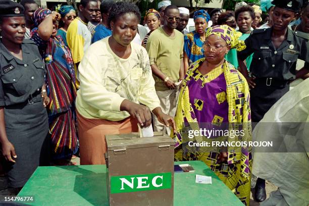 Voters put their ballot in the NEC box at the polling station, on June 12 during Nigeria's first presidential election after 10 years of military...