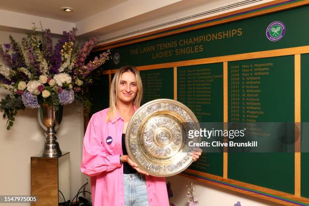 Marketa Vondrousova of Czech Republic holds the Women's Singles Trophy following her victory in the Women's Singles Final on day fourteen of The...