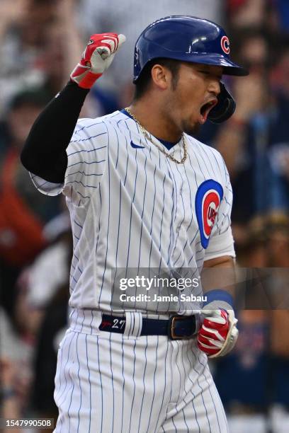 Seiya Suzuki of the Chicago Cubs celebrates after hitting a two-run single in the sixth inning against the St. Louis Cardinals at Wrigley Field on...