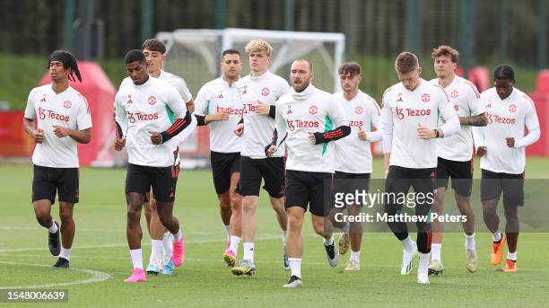 Maxi Oyedele, Marcus Rashford, Toby Collyer, Christian Eriksen, Scott McTominay of Manchester United arrives ahead of a pre-season training session...