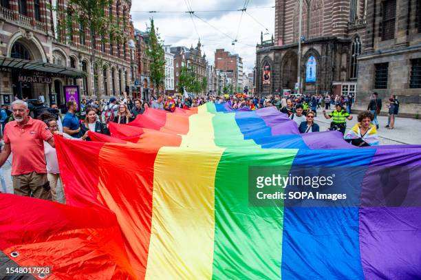 People seen marching with a huge rainbow flag during the parade. The annual equal rights demonstration for the global rainbow community took place in...