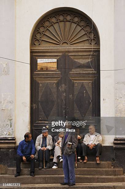 Maghreb Place or the ancient Bastille place on April 8 in Oran, Algeria. Some men are having a discussion at the entrance of a Catholic church.