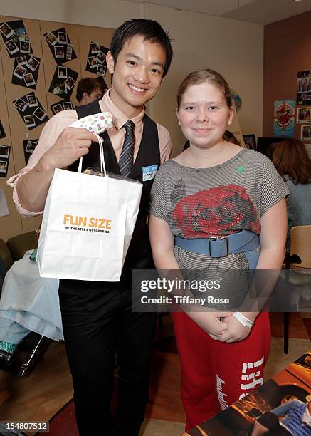 Actor Osric Chau poses with a patient at "Fun Size" Special Screening At Children's Hospital Los Angeles at Childrens Hospital Of Los Angeles on...