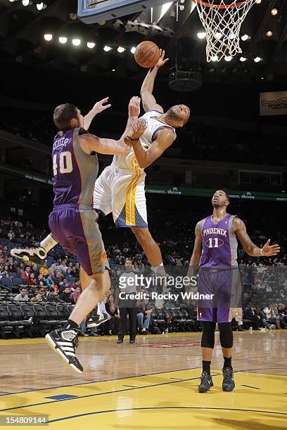 Carlon Brown of the Golden State Warriors goes up for a shot against Luke Zeller of the Phoenix Suns on October 23, 2012 at Oracle Arena in Oakland,...