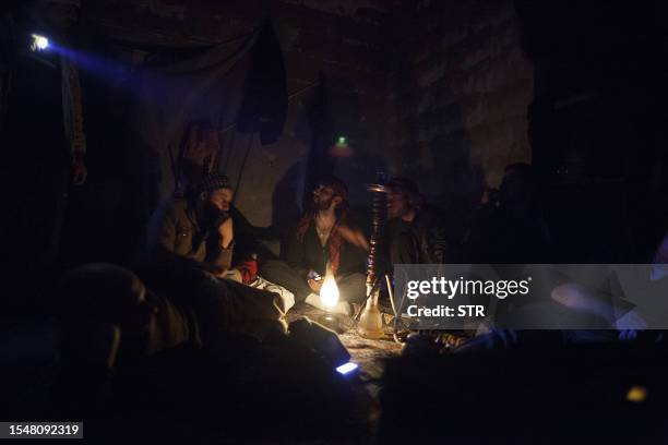 Defected Syrian soldiers, now members of the Free Syrian Army, rest at their mountain outpost near the village of Janudieh in the northern province...