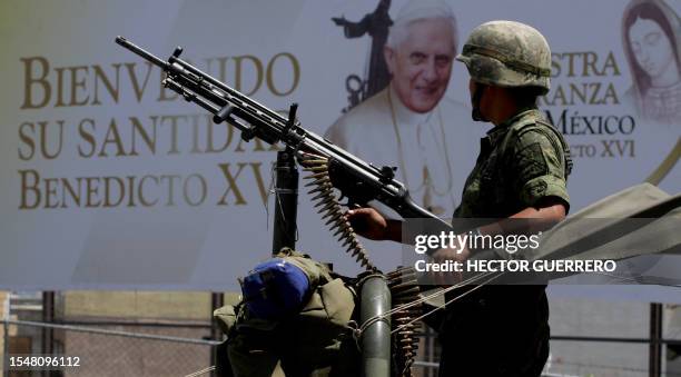 Mexican soldier patrols the streets of Leon, in Guanajuato state, Mexico, on March 23, 2012 hours before the arrival of Pope Benedict XVI. On his...