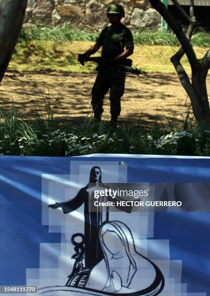 Mexican soldier patrols the streets of Leon, in Guanajuato state, Mexico, on March 23, 2012 hours before the arrival of Pope Benedict XVI. On his...