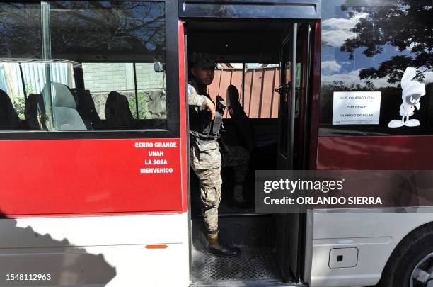 Soldiers of the Honduran Army armed with M-16 rifles provide security on public buses in Tegucigalpa on March 1, 2012. To combat the increasing...