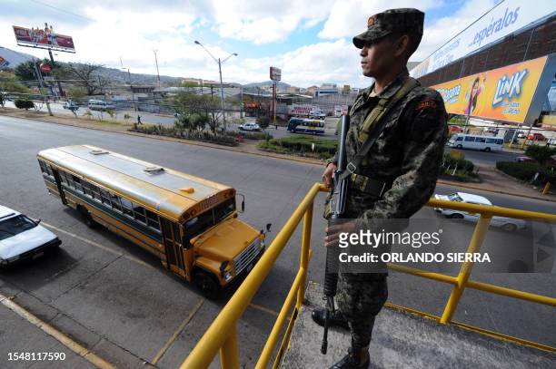 Soldier of the Honduran Army armed with an M-16 rifle provides security on public bus route in Tegucigalpa on March 1, 2012. To combat the increasing...
