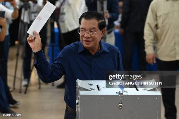 Cambodia's Prime Minister Hun Sen prepares to cast his vote at a polling station in Kandal province on July 23, 2023 during the general elections.