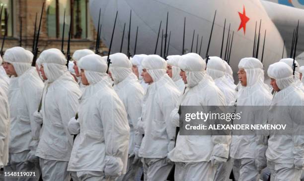 Wearing white winter camouflage smocks and carrying the WWII-era Mosin rifles Russian soldiers march at the Red Square in Moscow, on November 7...