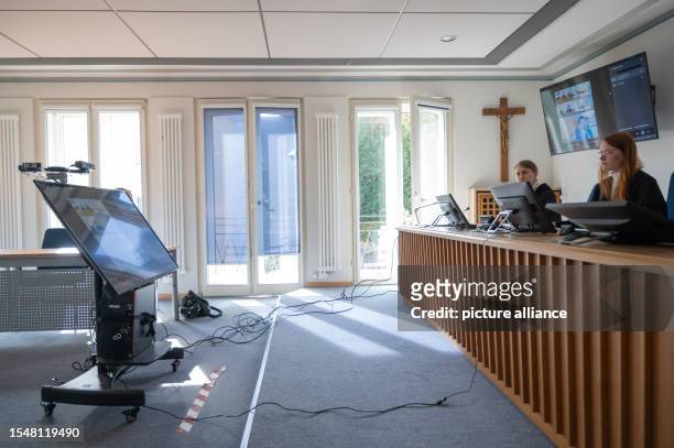 July 2023, Rhineland-Palatinate, Trier: A monitor with four cameras and other monitors on the wall and on the judge's table are set up for a video...