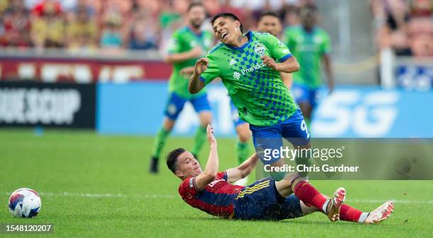 Brian Oviedo of Real Salt Lake takes out Raul Ruidiaz of the Seattle Sounders during the first half of their Leagues Cup game at America First Field...