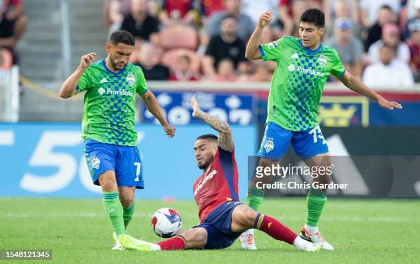 Cristian Arango of Real Salt Lake slide tackles the ball away from Cristian Roldan and Obed Vargas of the Seattle Sounders during the first half of...