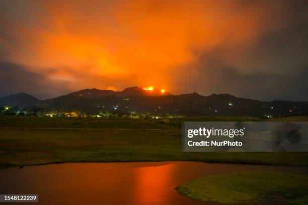 Mountain wildfire and milky way seen from a Teldeniya old town in Kandy, Sri Lanka, on July 22, 2023