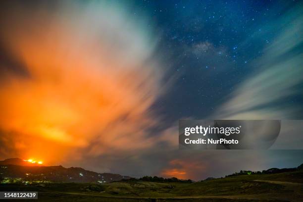 Mountain wildfire and milky way seen from a Teldeniya old town in Kandy, Sri Lanka, on July 22, 2023