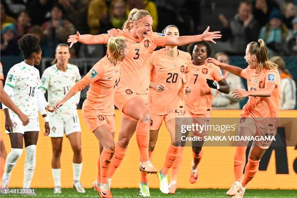 Netherlands' defender Stefanie van der Gragt celebrates with her teammates after scoring her team's first goal during the Australia and New Zealand...