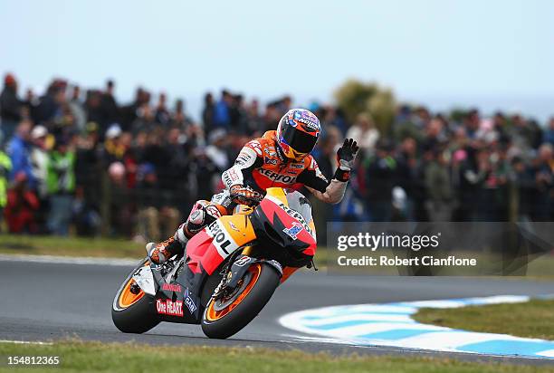 Casey Stoner of Australia and rider of the Repsol Honda Team Honda waves to the crowd after practice for the Australian MotoGP, which is round 17 of...
