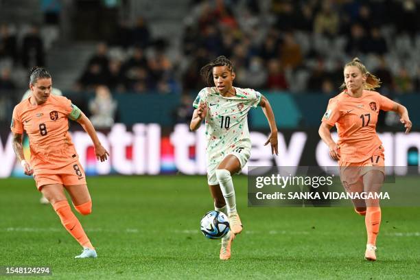 Portugal's forward Jessica Silva , Netherlands' midfielder Victoria Pelova and Netherlands' midfielder Sherida Spitse vie for the ball during the...