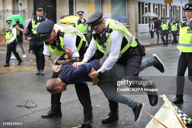 Police officers arrest a protester during the demonstration. The freedom protesters feel that many of the government's policies are taking their...