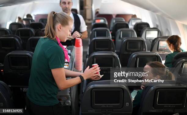 Brisbane , Australia - 23 July 2023; Republic of Ireland's flight attendant Ruesha Littlejohn attends to Harriet Scott during their flight from their...
