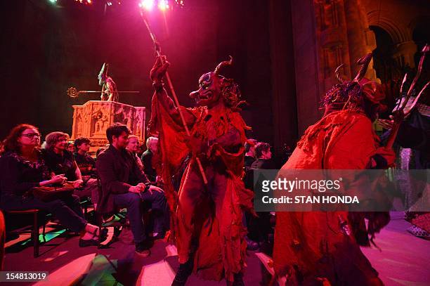 Masked actors walk during "The Grand Procession of the Ghouls" at the Halloween Extravaganza and Procession of the Ghouls October 26, 2012 at the...