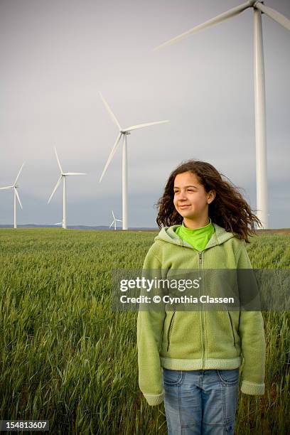 girl (11) standing in field, front view - cynthia classen ストックフォトと画像