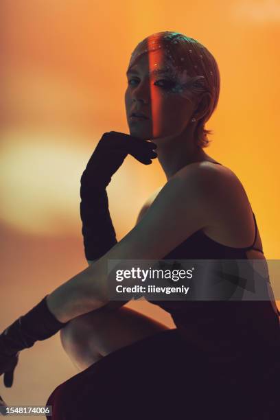 blonde fashion model in retro dress in studio with neon lighting. beauty makeup - runway night stock pictures, royalty-free photos & images