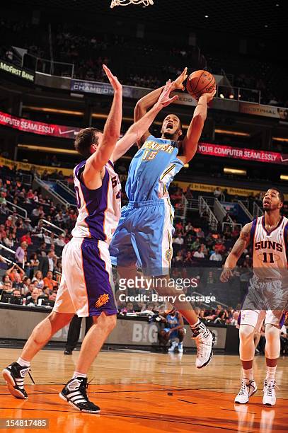 Anthony Rudolph of the Denver Nuggets puts a shot up against the block of Luke Zeller of the Phoenix Suns during a pre-season game on October 26,...