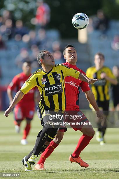 Leo Bertos of Wellington competes with Iain Ramsay of Adelaide during the round four A-League match between Adelaide United and the Wellington...