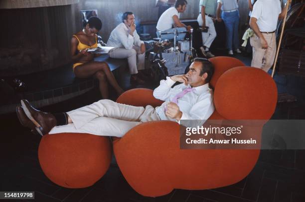 Actress Trina Parks and Scottish actor Sean Connery relax between takes on the set of the James Bond film 'Diamonds Are Forever', USA, 1971. They are...