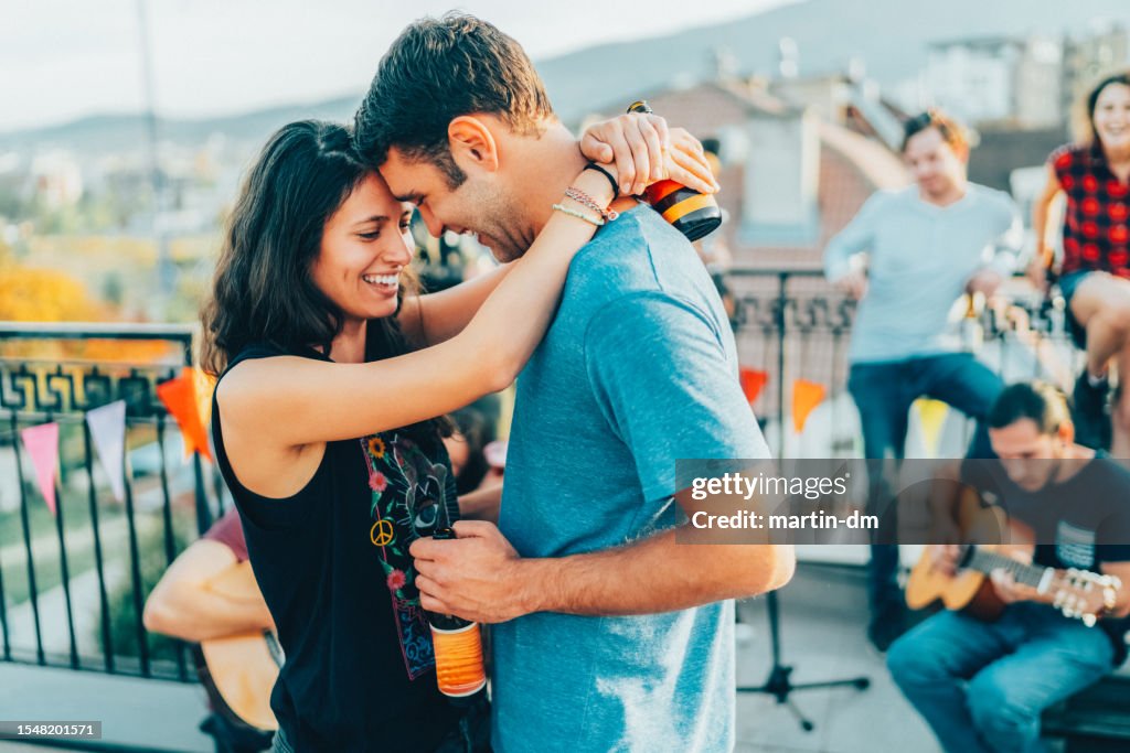 Friends drinking and partying on the rooftop