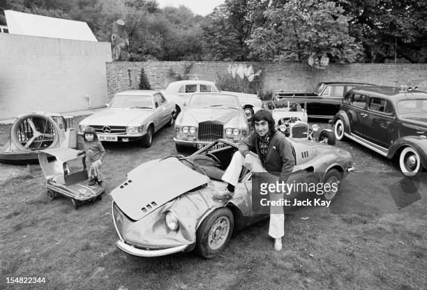 Drummer Keith Moon , of British rock group The Who at Tara, his home in Chersey, Surrey, with his daughter, Amanda , and some of the cars in his...
