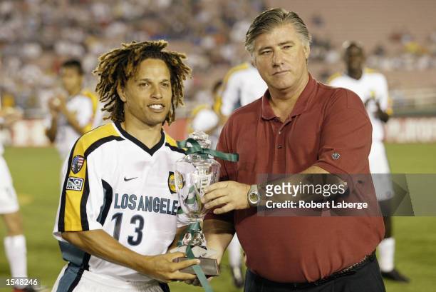 Cobi Jones of the Los Angeles Galaxy is presented with the Western Conference Champion Trophy prior to the start of the game against the Kansas City...