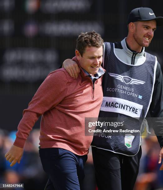 Robert MacIntyre of Scotland celebrates with his caddie Greg Milne after finishing his round on the 18th green during Day Four of the Genesis...
