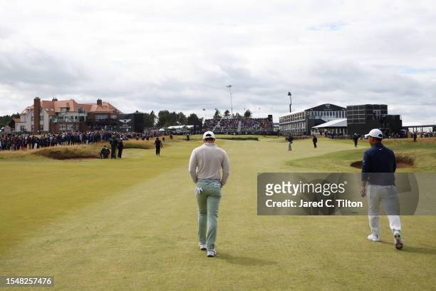 Rory McIlroy of Northern Ireland and Tom Kim of South Korea walk on the 18th hole during Day Four of the Genesis Scottish Open at The Renaissance...