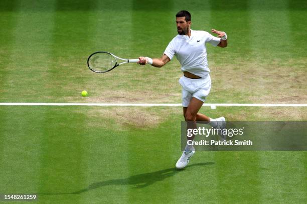Novak Djokovic of Serbia plays a forehand in the Men's Singles Final against Carlos Alcaraz of Spain on day fourteen of The Championships Wimbledon...