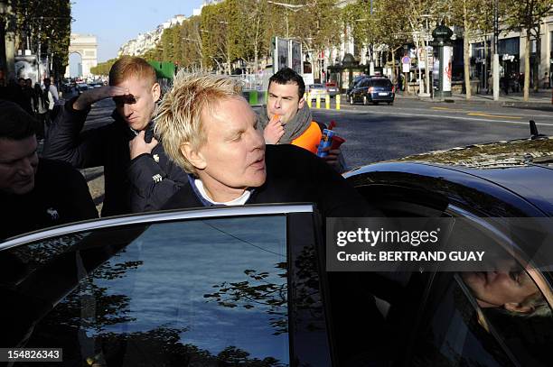 Mike Jeffries, CEO of US clothing retailer Abercrombie & Fitch leaves the store on the Champs Elysees avenue in Paris on October 27 as some workers...