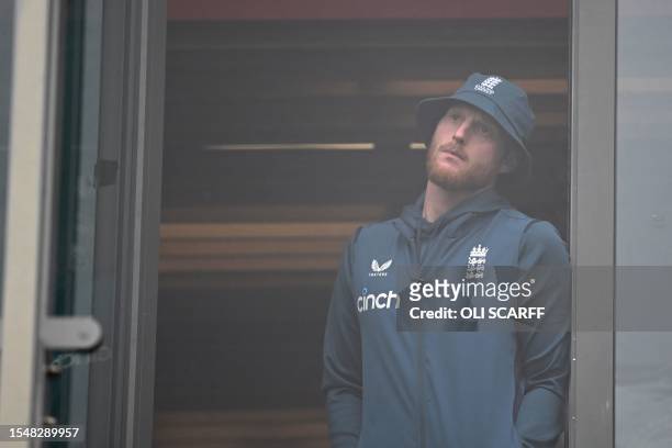 England's captain Ben Stokes looks on from the balcony as rain delays the start of play on day five of the fourth Ashes cricket Test match between...