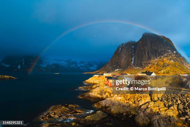 rainbow over reine, lofoten islands, norway - extreme weather norway stock pictures, royalty-free photos & images