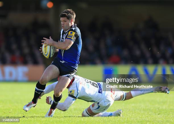 Dan Hipkiss of Bath skips the tackle of Tom Johnson of Exeter during the Aviva Premiership match between Bath and Exeter Chiefs at the Recreation...